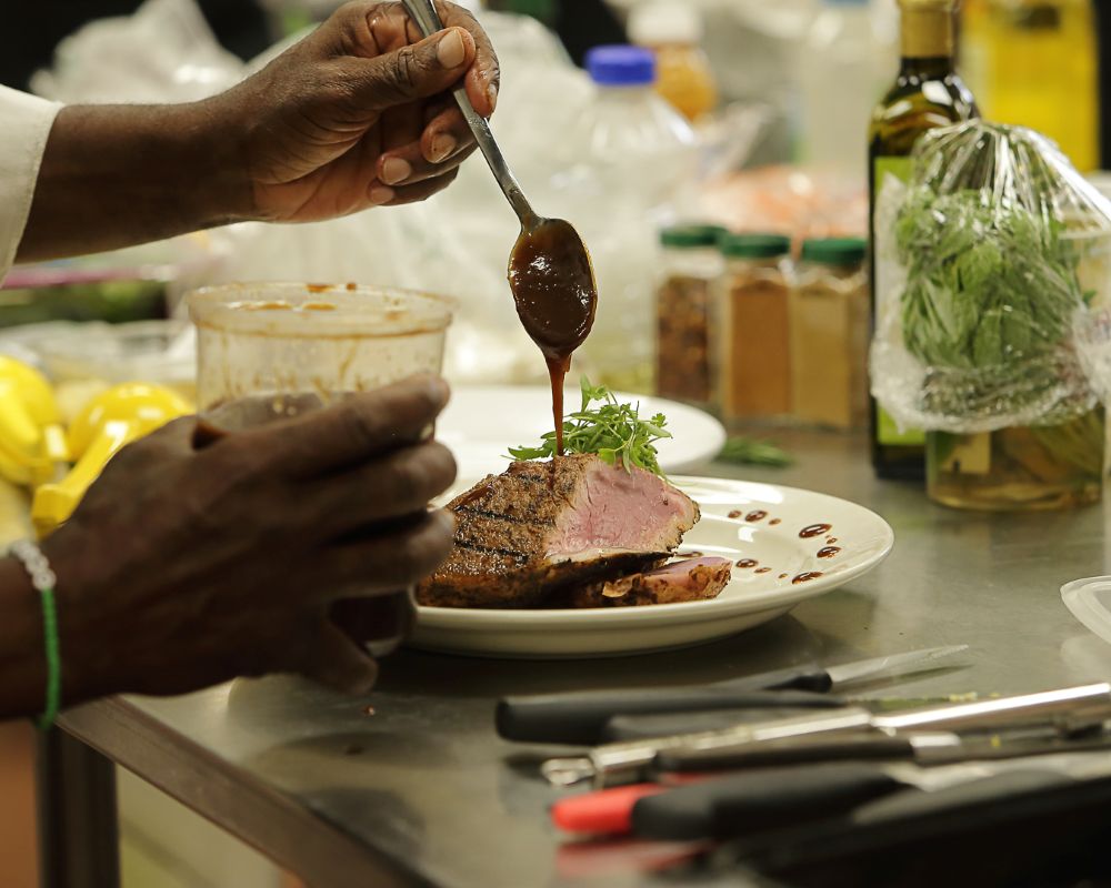 Chef Bernard Displays a Handmade Sauce